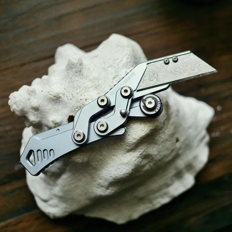 The Stinger Tools Stinger Godzilla Blade folding pocket knife in space grey, shown open with belt clip
