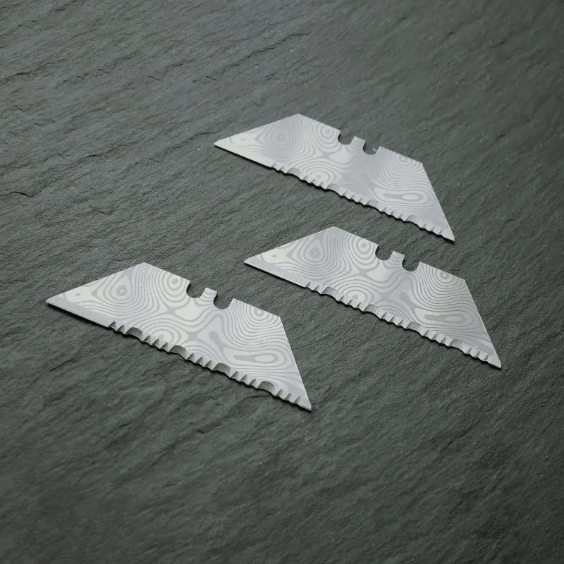 The Stinger Tools Stinger P01 Partially Serrated Utility Blade Replacement, 10-pack laser-engraved damascus style blades