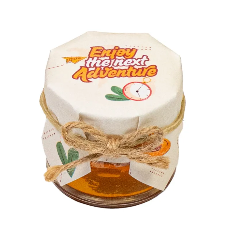 HoneySpree Enjoy The Adventure mini honey jar, close-up of golden honey in small glass jar