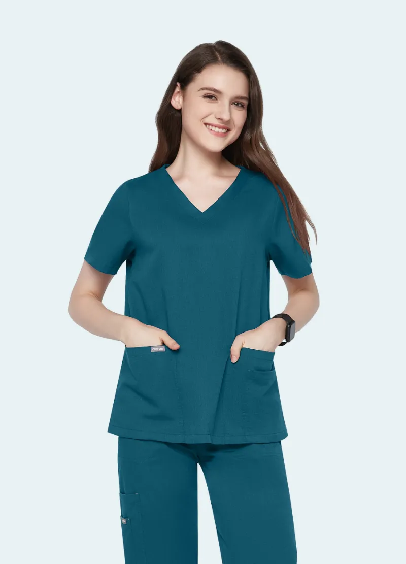 COMENII ElegCare Essential Scrub Top Caribbean Blue showing V-neck, sleeve pocket, and welt pockets