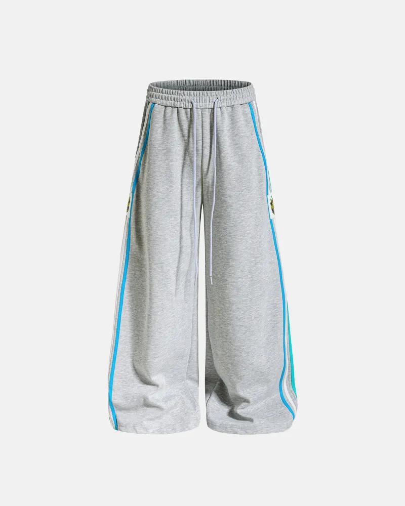 INFLATION Contrast Stripe Barrel Sweatpants with side stripe panels and crest patch