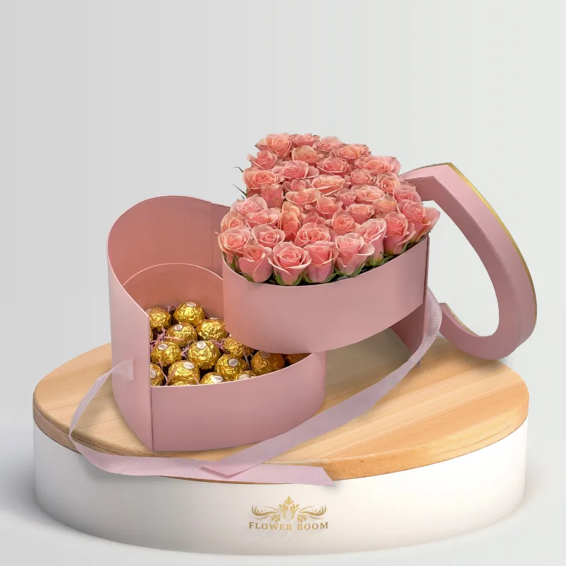 Flower Boom Dallas Pink Roses And Hazelnut Chocolates In A Two Tier Heart Shaped Box with pink bow