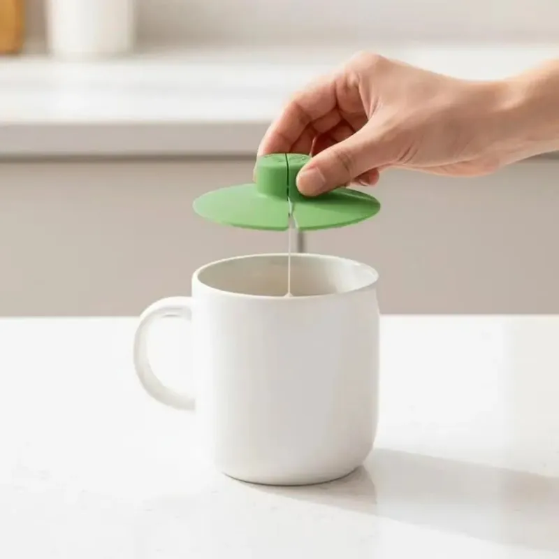 Kicklo 2-in-1 Silicone Mug Lid & Tea Bag Holder on top of tea cup with bag secured