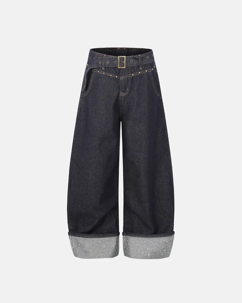 INFLATION Belted Studded Cuff Barrel Jeans in dark indigo with metal studded cuffs and grommet belt