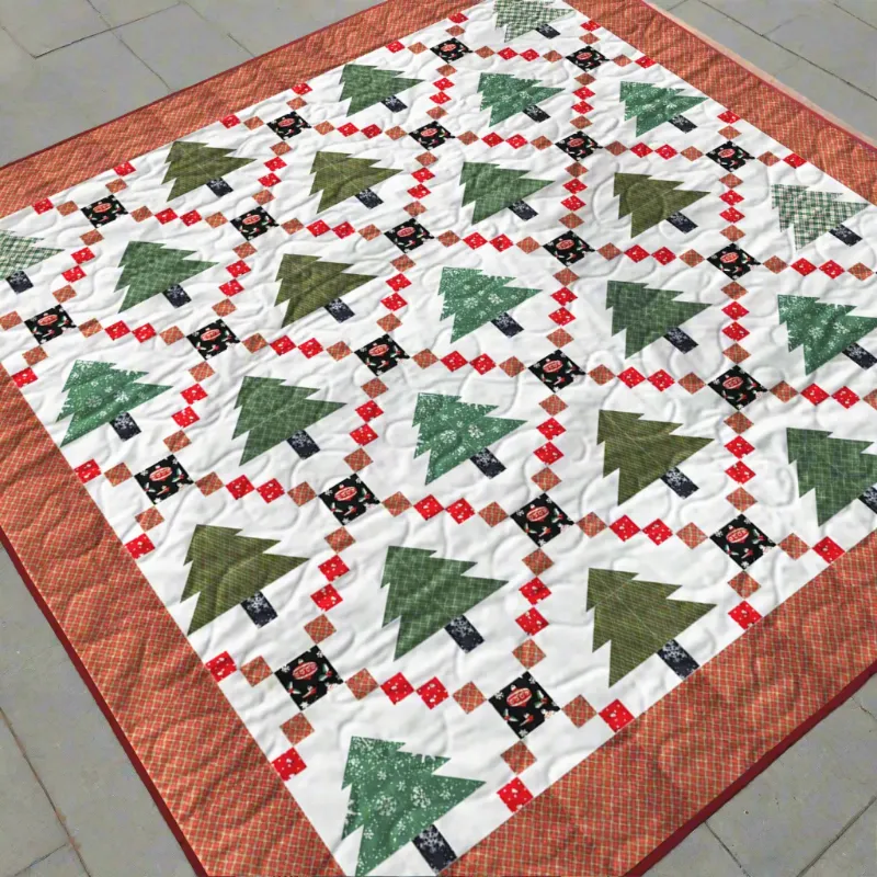Boho Blanket Festive Pines Quilt Pattern showing a bold pine-themed quilt in layered colours