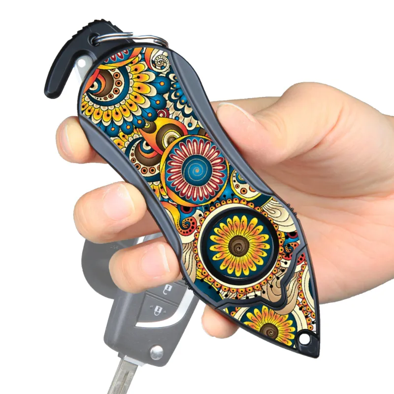 The Stinger Tools Stinger Personal Safety Alarm Keychain in Mandala with siren, seatbelt cutter, and glass breaker