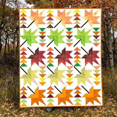Boho Blanket Autumn Whispers Quilt Pattern, a graphic tree-ring quilt design shown in layered autumn fabrics