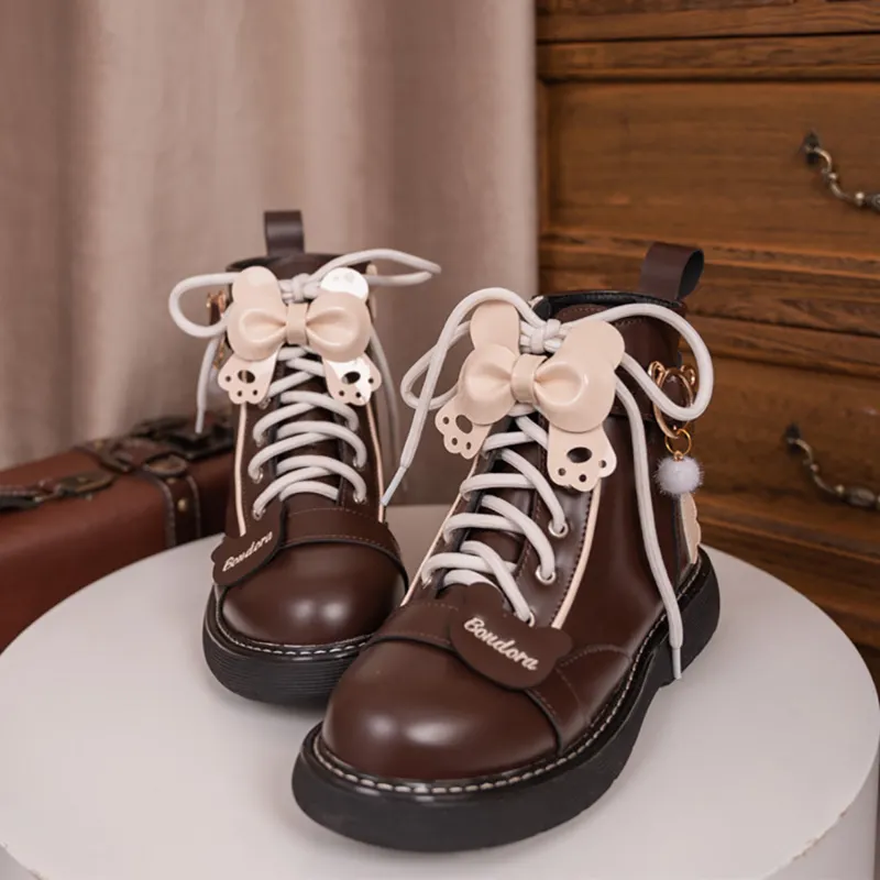 Juwas Bear Paw Bow High Ankle Boots styled on feet highlighting the rear bow detail and smooth finish