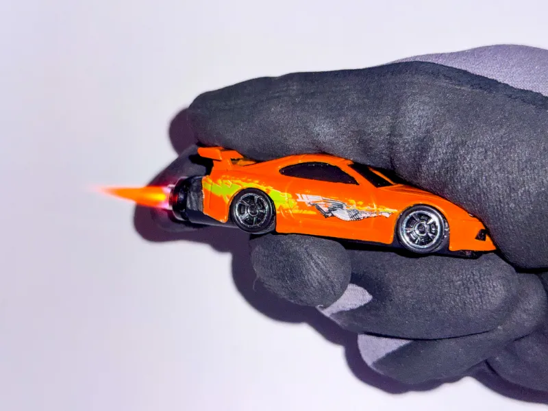 SoCal Divinity Fast and Furious Supra Refillable Lighter showing iconic orange car design