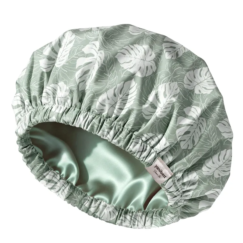 Yanibest Butter Satin Lined Waterproof Shower Cap in fresh green shown on a stand
