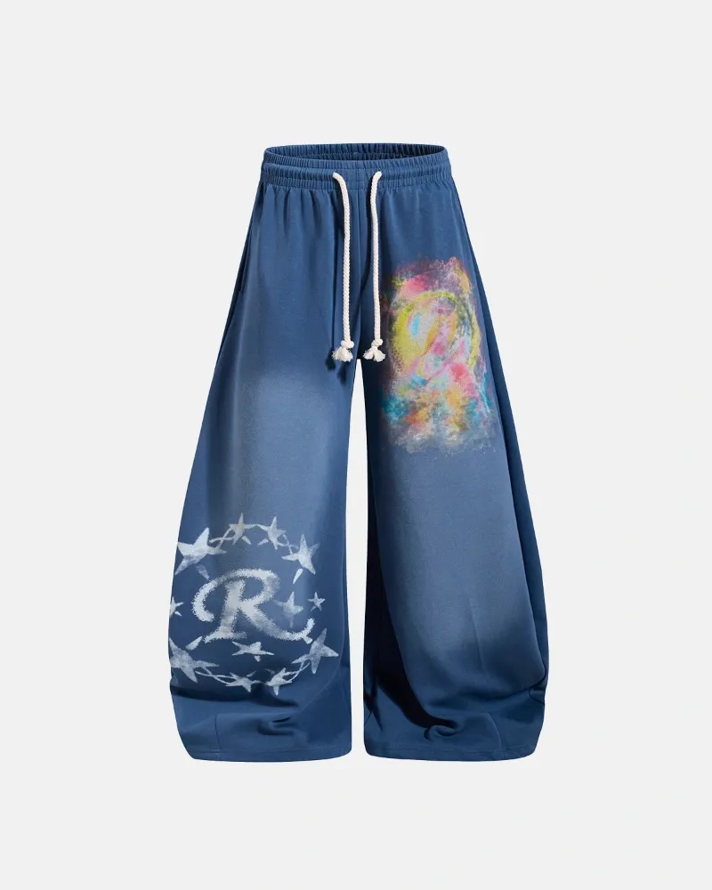 INFLATION Airbrush Graphic Barrel Sweatpants in black with colorful abstract spray-style graphics and star wreath design