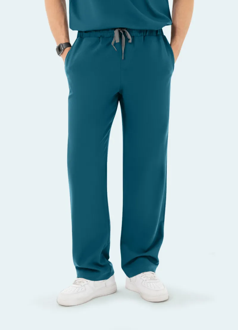 COMENII DynaComfort™ Essential Scrub Pant in Caribbean Blue shown full-length, highlighting the colour, straight-leg fit and pockets