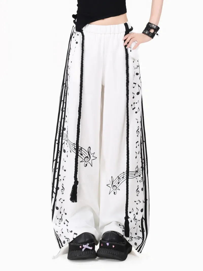 Juwas Black and White Music Note Wide Leg Pants model wearing the trousers showing the full length drape.