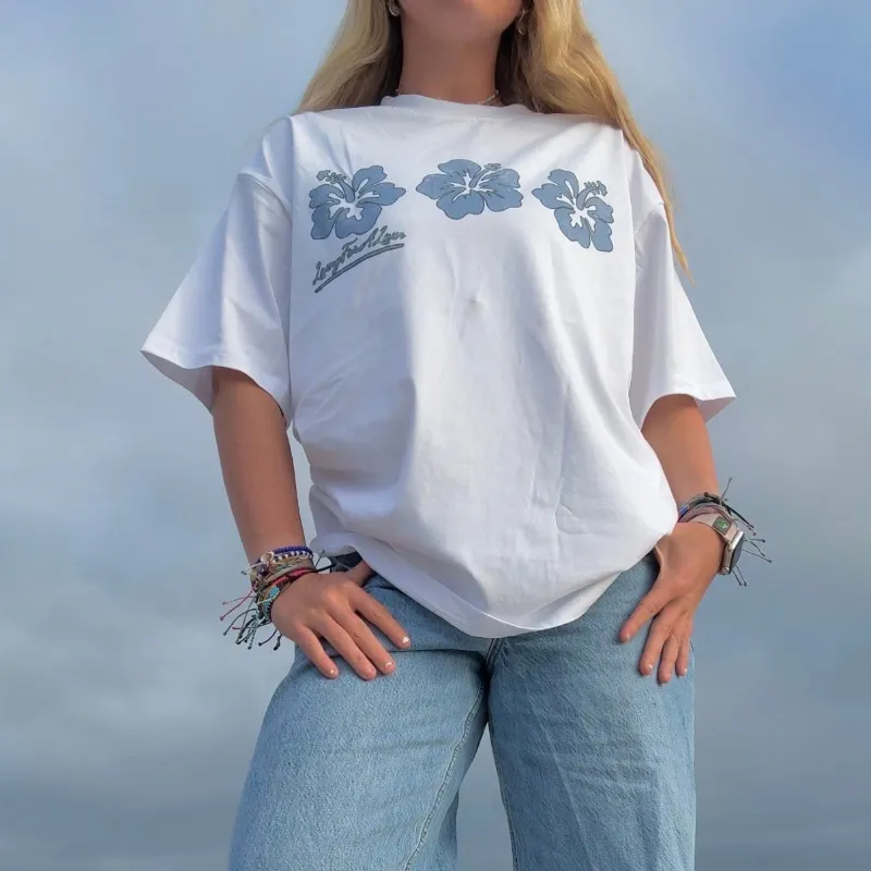 LivingForALivin Hibiscus Loose Tee showing a loose-fit unisex t-shirt with bold hibiscus print