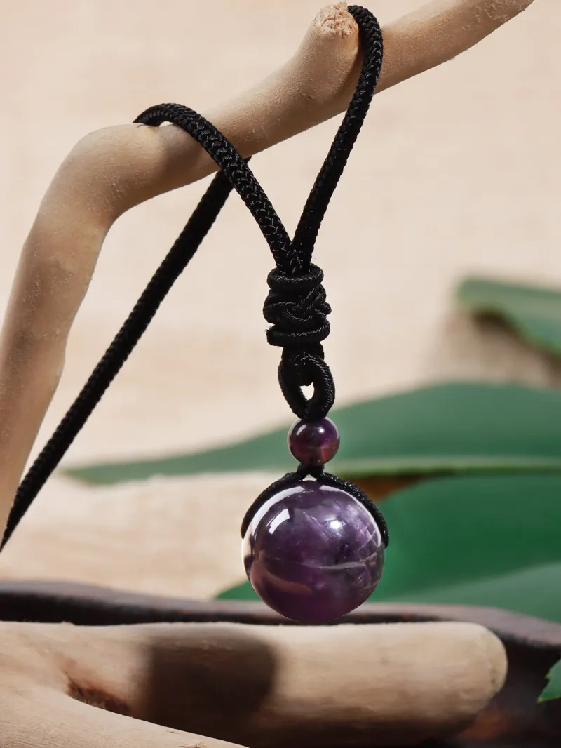 Turix Amethyst Sphere Necklace with polished purple crystal sphere on adjustable black cord
