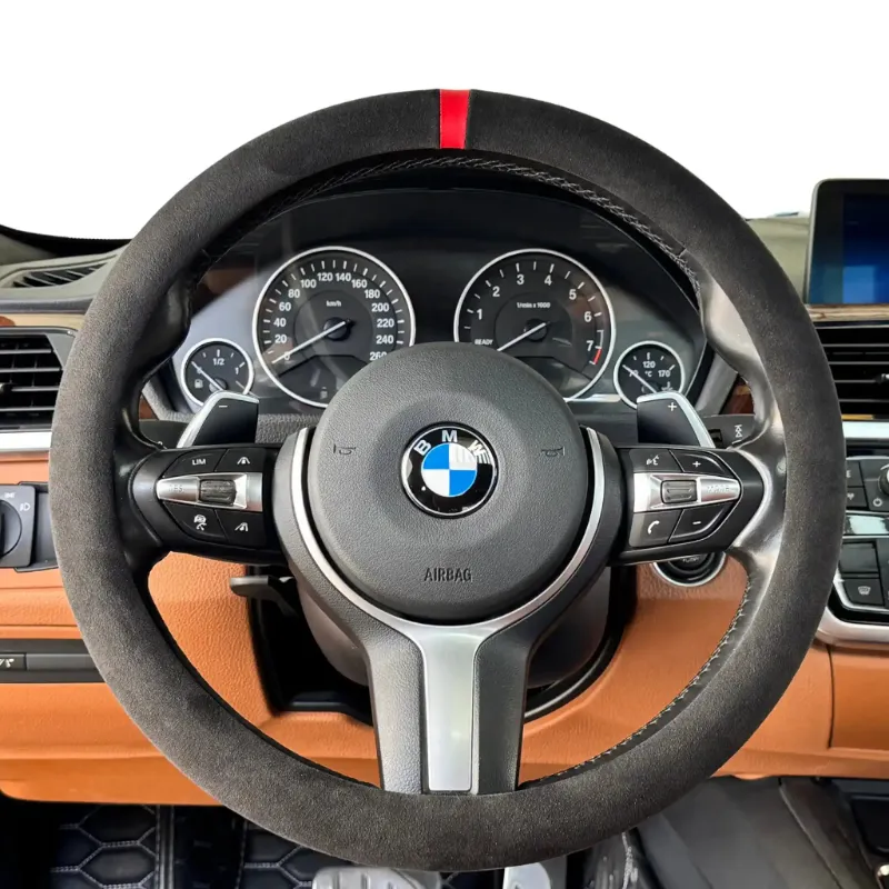 Luxus Car Mats Alcantara Full Steering Wheel Cover in Nero black shown on a steering wheel