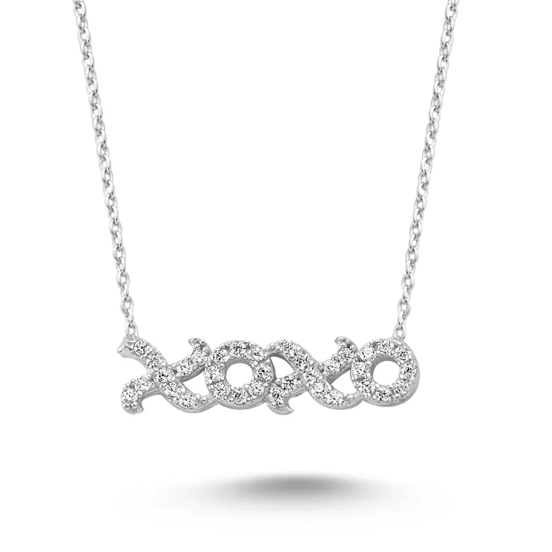 Amorium Jewelry Dainty XOXO Silver Necklace Pendant, close-up of silvery pendant with sparkling crystals on chain
