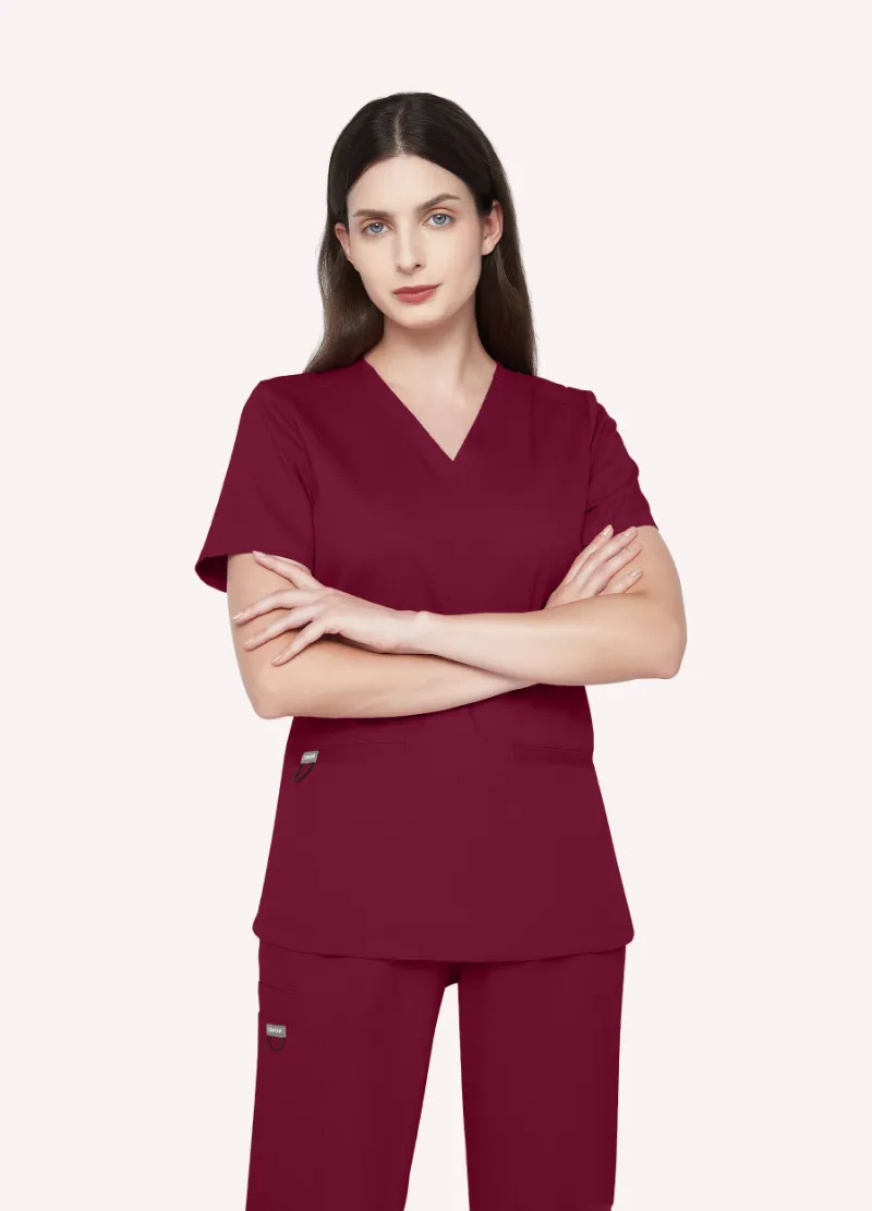 COMENII SoftTouch Essential Scrub Top in Burgundy, front view showing tailored fit and welt pockets
