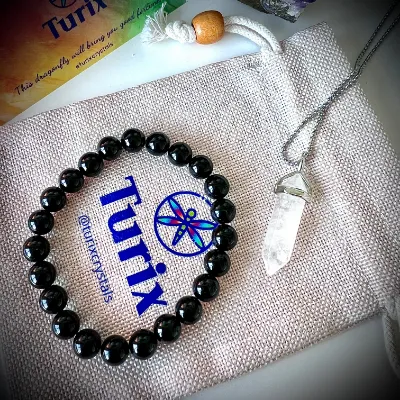 Turix Energy Protection Pairing showing Black Onyx bracelet and Clear Quartz crystal point pendant necklace