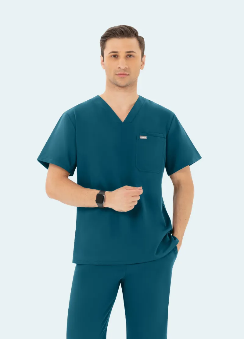 COMENII DynaComfort Essential Scrub Top Caribbean Blue front view showing V-neck and chest pockets