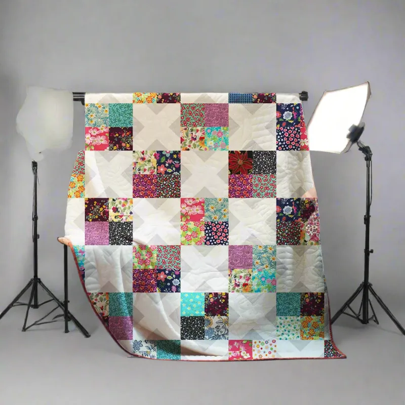 Boho Blanket Blooming Beauty Quilt Pattern, a floral block quilt shown as a 50 inch square throw