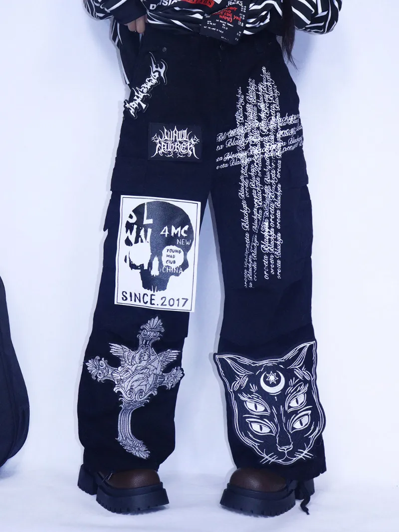 Juwas Black Gothic Cat Cross Cargo Pants showing pockets and print.