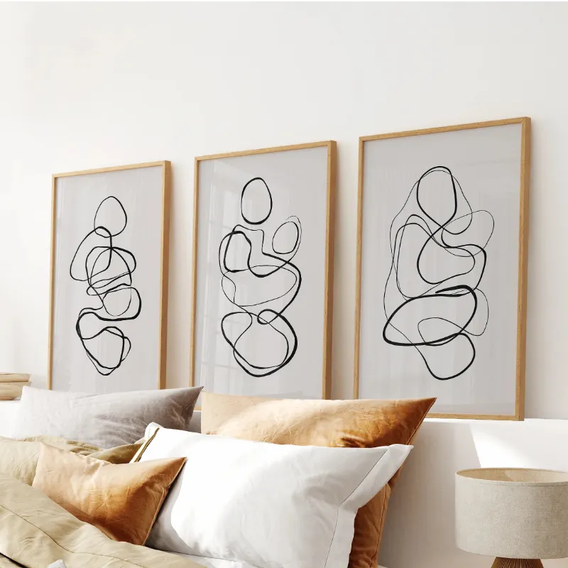 Wall Art Set Abstract Line Art Wall Art Set of 3. Minimalist Figure Drawings showing three black line figure sketches on neutral backgrounds