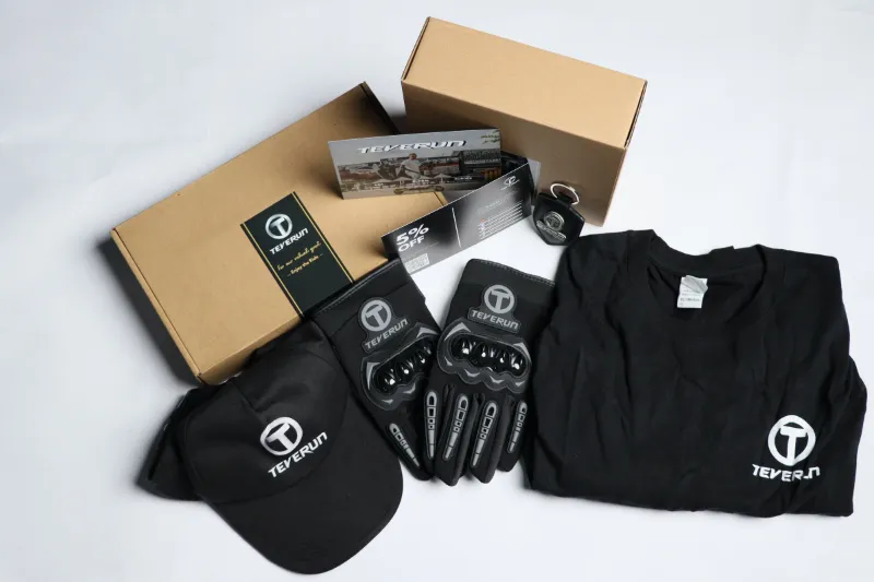 TEVERUN USA Rider Gift Pack with riding gloves, baseball cap, T-shirt and keychain laid out together