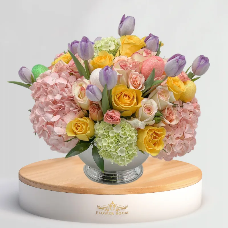 Flower Boom Dallas Pastel Easter Centerpiece with spring flowers and decorative eggs in silver vase