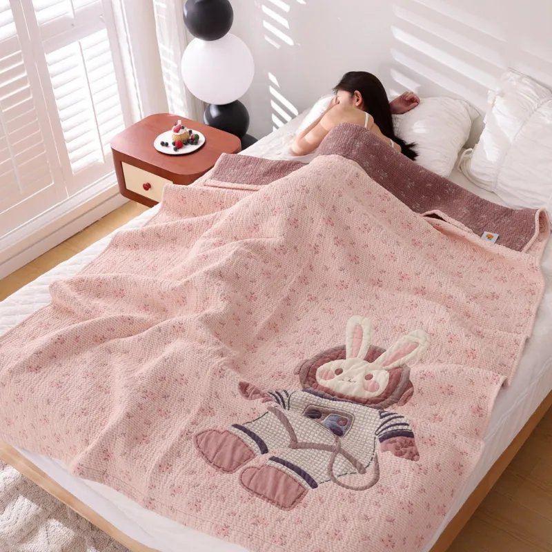Juwas Astronaut Bunny Blanket folded neatly on a bed showing the cute bunny design.