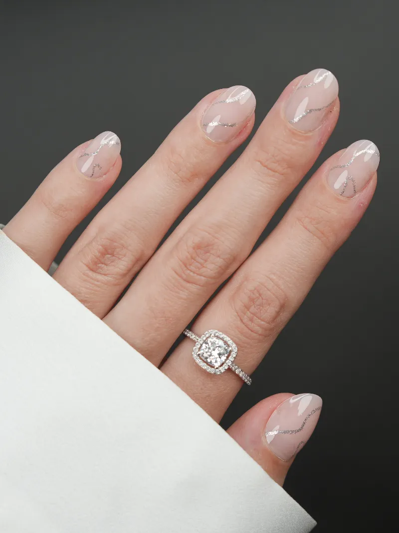 Roxy Nails Paris Radiance press on nails with silver swirl glitter on nude base, extra-short round shape