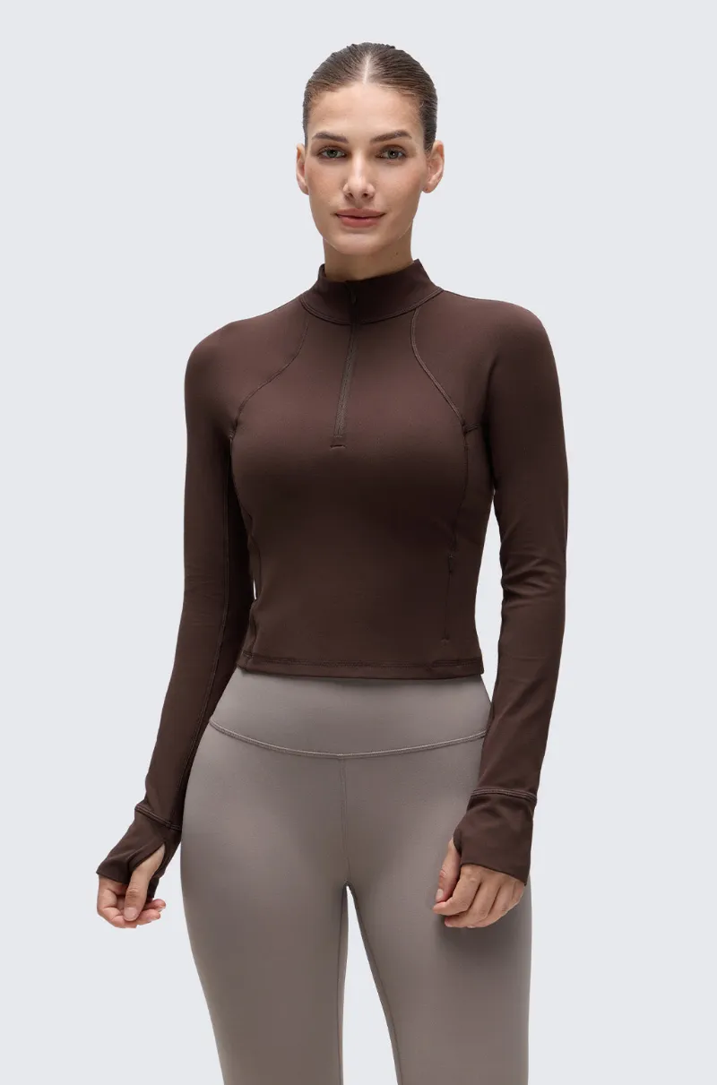 Essenther Global Half Zip Long Sleeve Cropped Top in soft athletic fabric with thumbhole detail