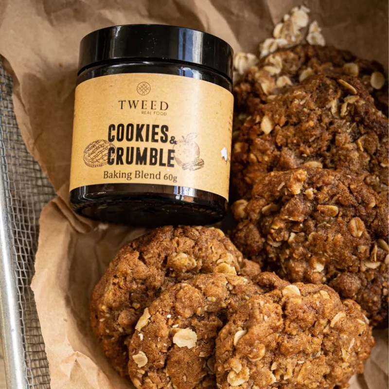 Tweed Real Food Cookies and Crumble Baking Blend jar beside baked cinnamon treats