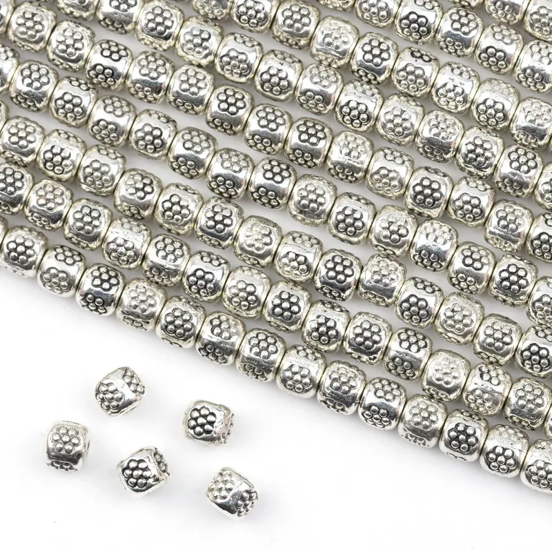 Cherry Tree Beads Thai style 3x5mm silver spacer beads with stamped daisies, strung in a line