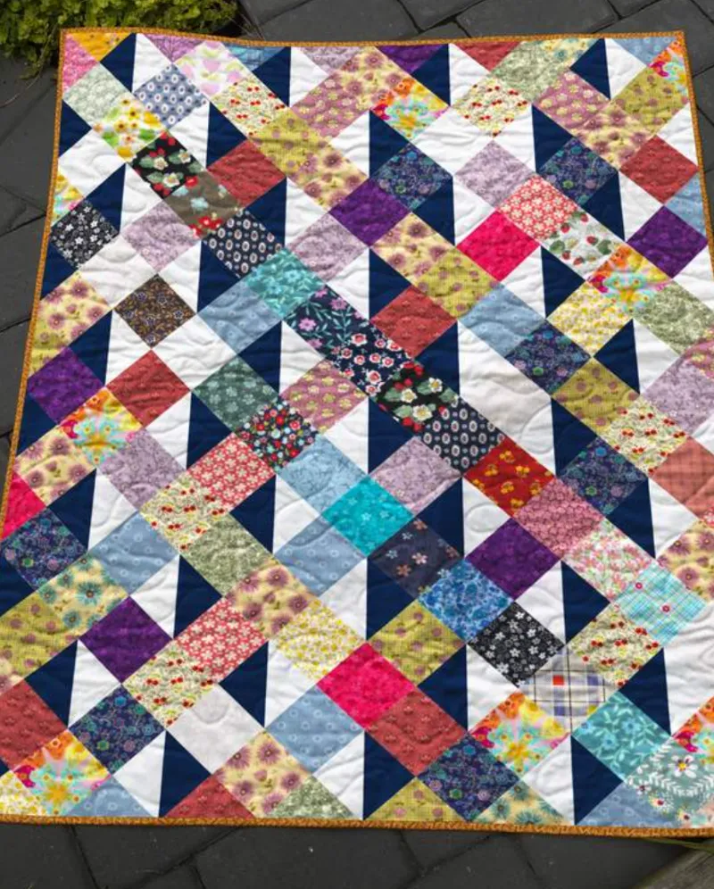 Boho Blanket Colorful Corners Quilt Pattern, a small colorful corner block quilt shown flat