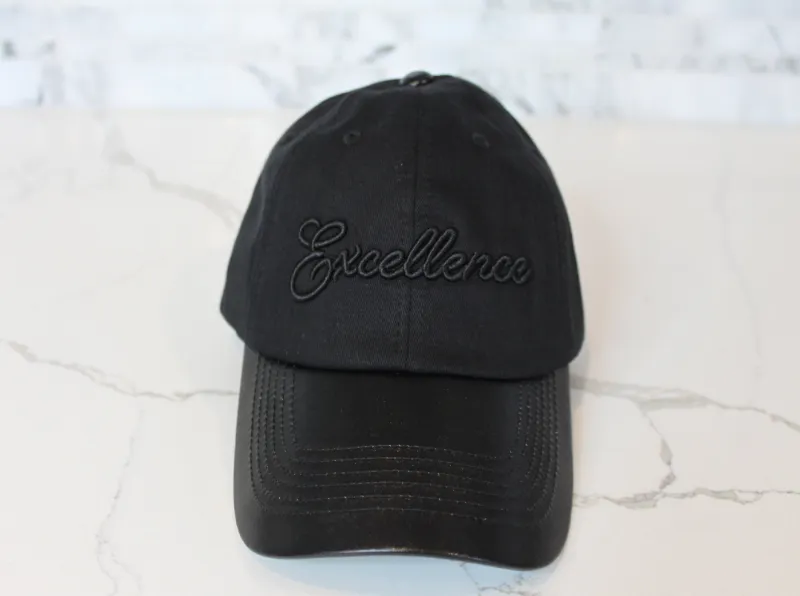 Embellished Black on Black Excellence Cap in black cotton with faux leather brim and embroidered text