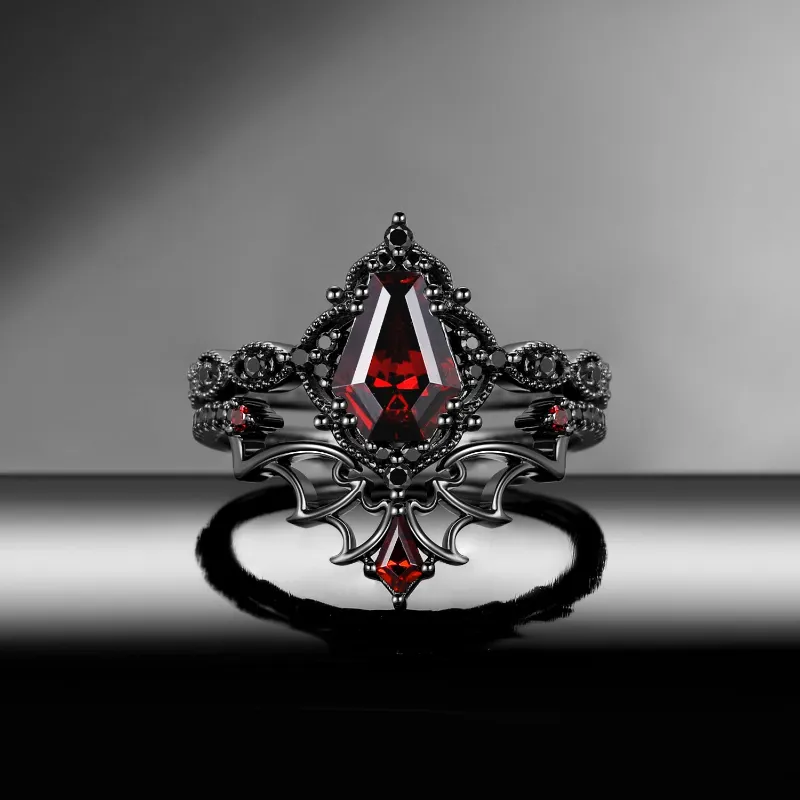 Starlandus 'Dark Romance' gothic garnet engagement ring set with coffin cut stone and bat wings