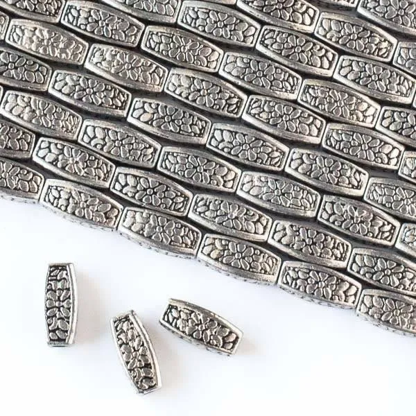 Cherry Tree Beads silver rice beads with flower pattern on an 8 inch strand