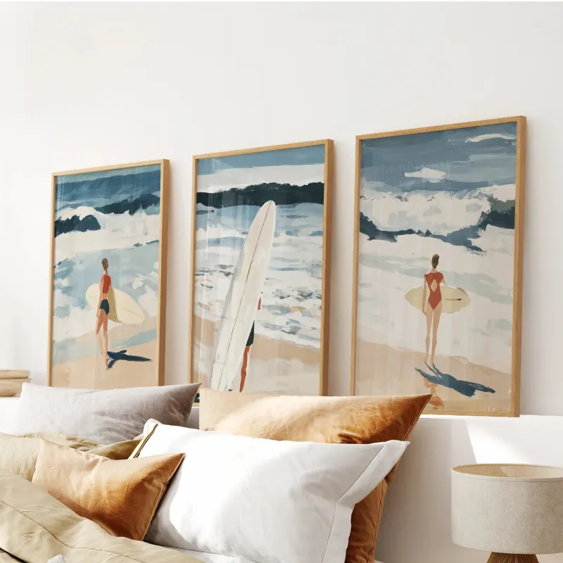 Wall Art Set Coastal Surf Wall Art Set of 3 showing three framed beach scene prints with surfers and waves