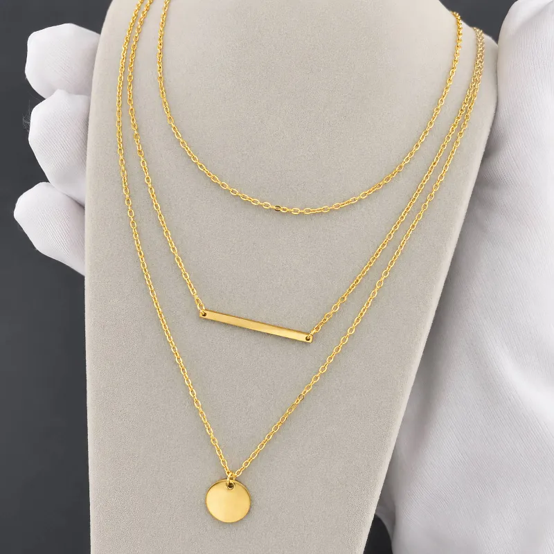 Viva Koutour Cosmetics Doll Layer Necklace – layered bar pendant and round charm necklace on display