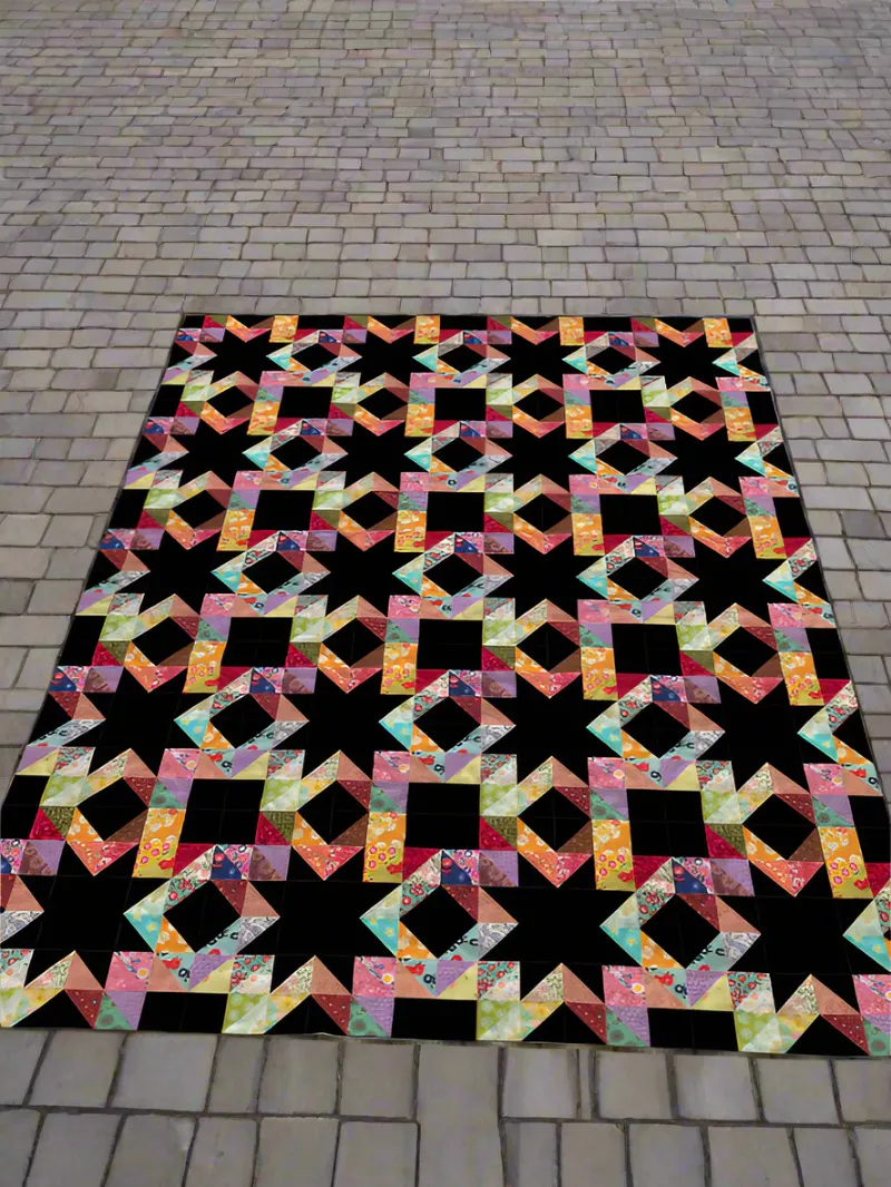 Boho Blanket Flower Night Mystery Quilt Pattern, a bold floral quilt shown in bed sizes