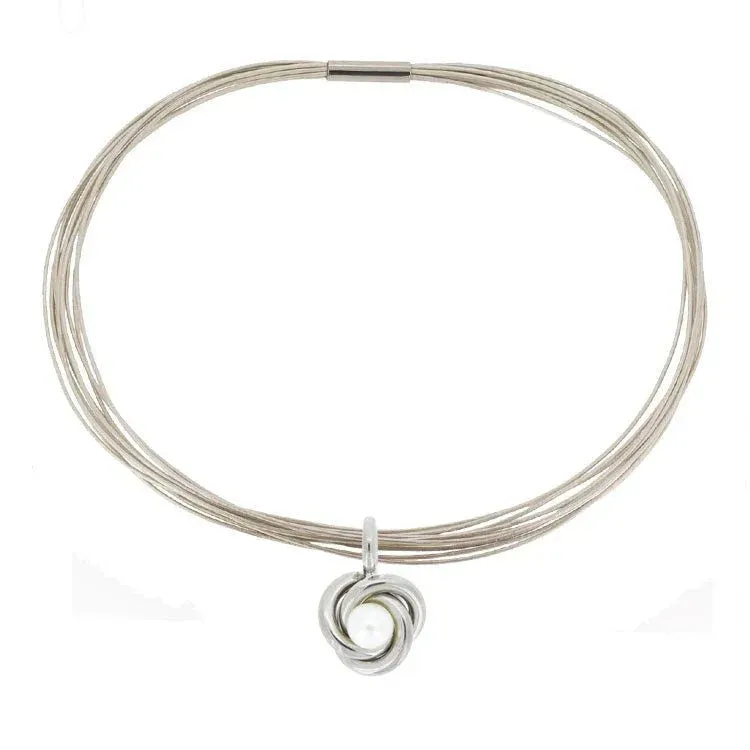 Nammi Celtic Knot Titanium Pendant with Pearl showing Celtic knot design with freshwater pearl on leather cord