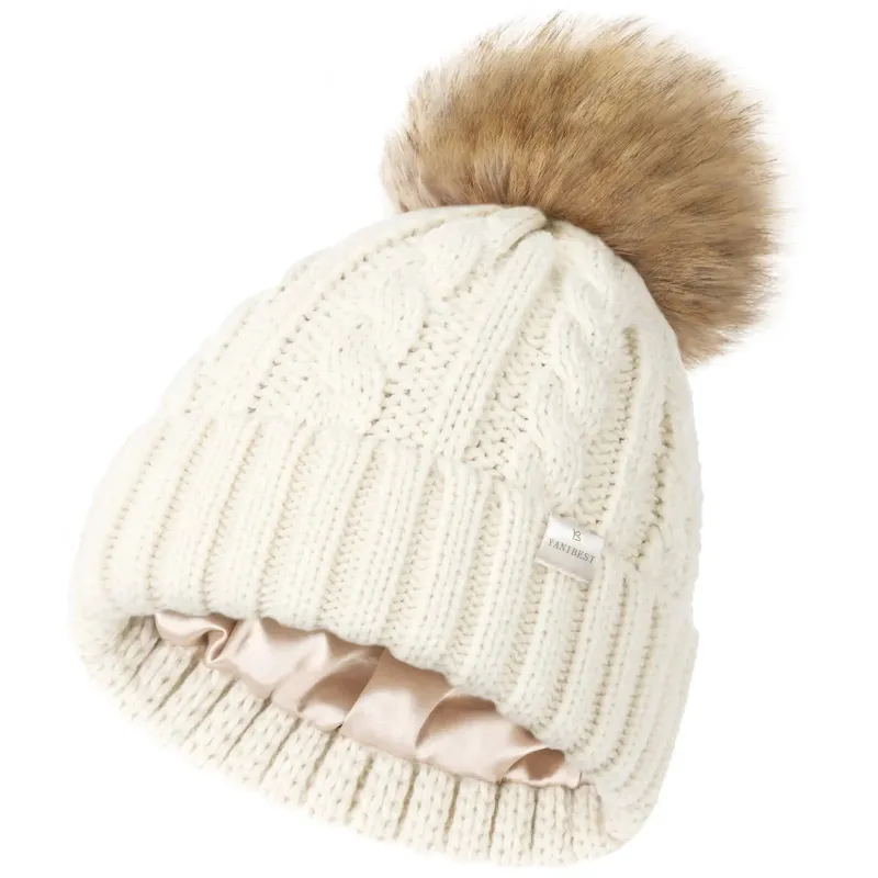 Yanibest Butter Satin Lined Pom Winter Beanie showing cable-knit exterior and faux fur pom