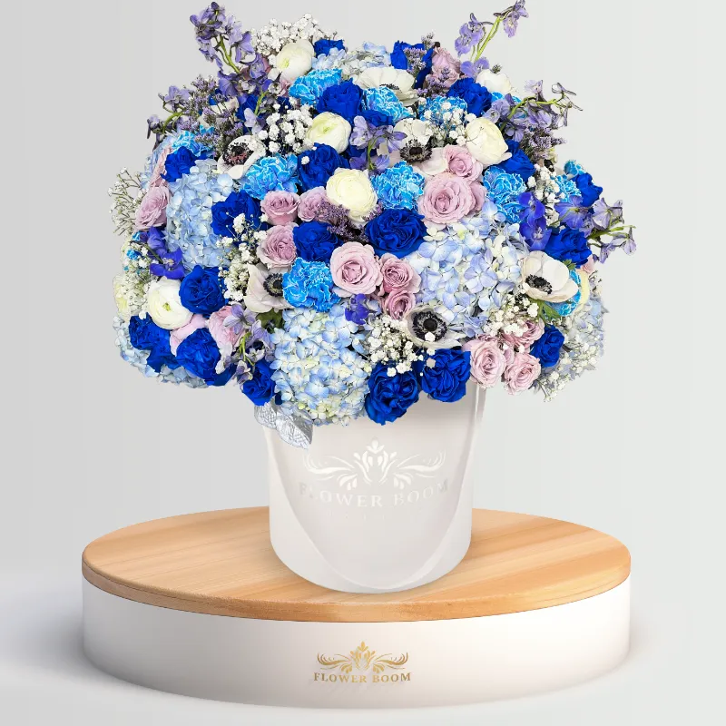Flower Boom Dallas Glimmering Azure arrangement with blue, lavender, and white flowers including roses and delphiniums