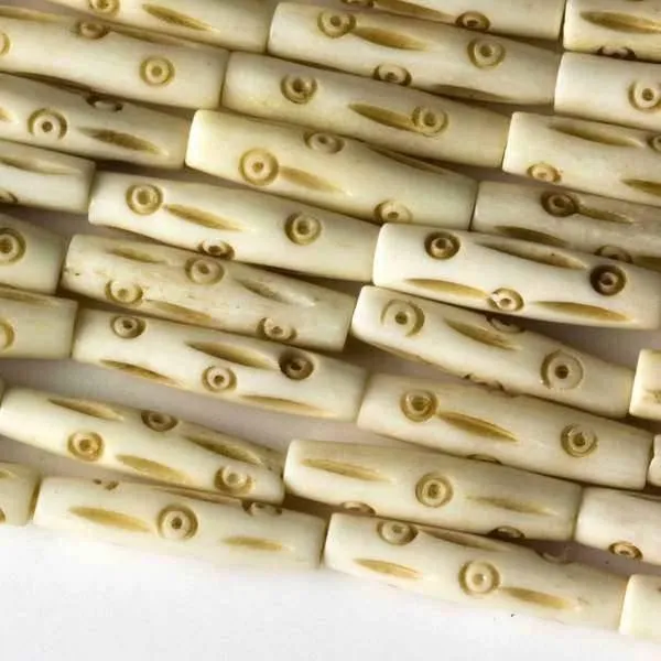 Cherry Tree Beads Bone natural tube beads with circles and lines on a strand