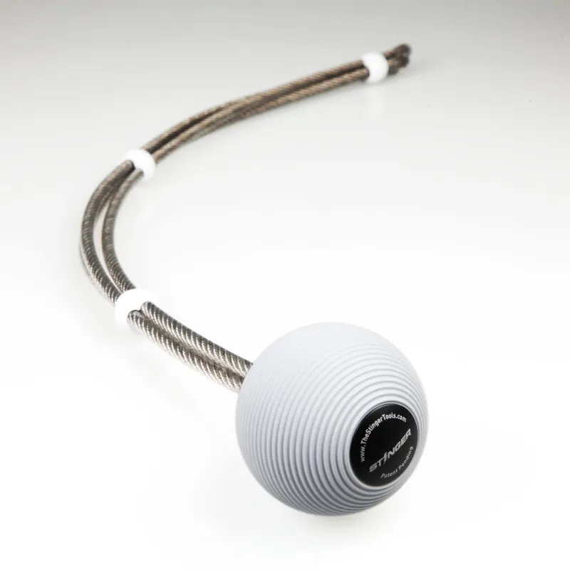 The Stinger Tools Stinger Trigger Point Massage Ball with attached whip on white background
