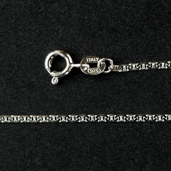 Cherry Tree Beads sterling silver flat chain necklace, 16 inch, coiled on a plain surface