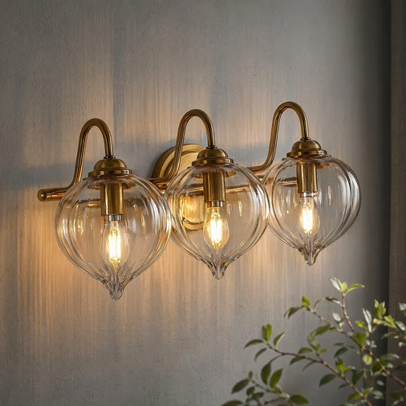 Tribesigns 3-Light Bathroom Light Fixtures with pumpkin glass shades and gold-plated metal frame