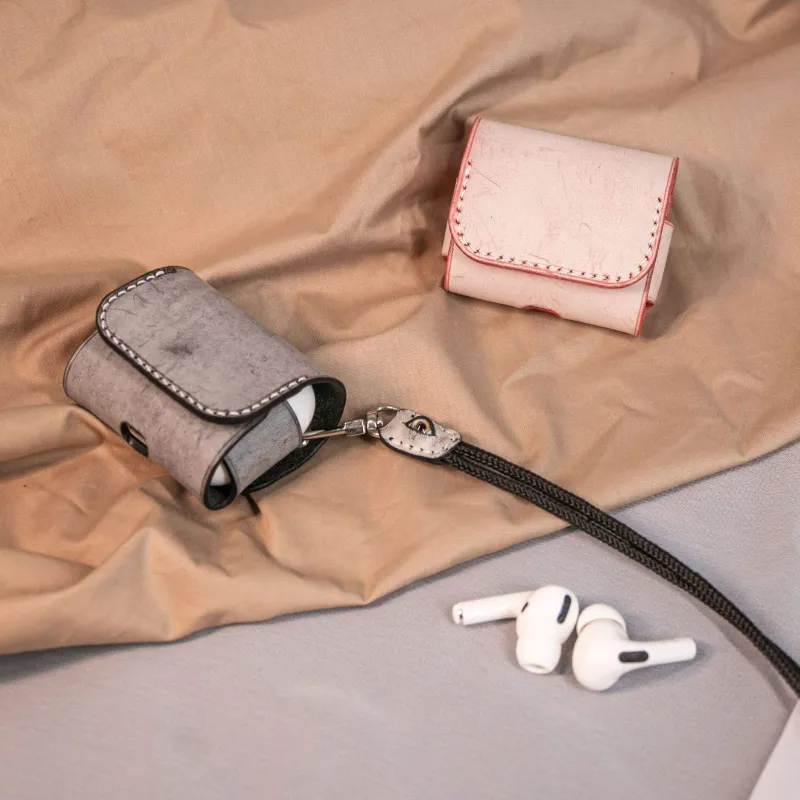 Techypop The Eyes Leather Protective Case for Apple AirPods, shown closed on a flat surface