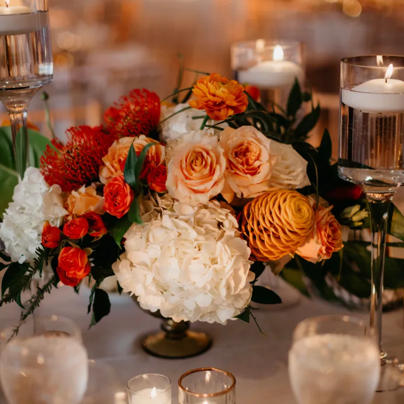Flower Boom Dallas Fall Wedding Centerpiece with orange roses and white hydrangeas in vase